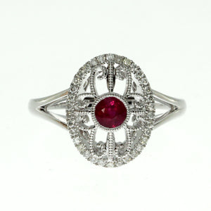  14 karat white gold ruby and diamond oval filigree ring containing one 0.36ct round ruby and 0.17cttw round diamonds.