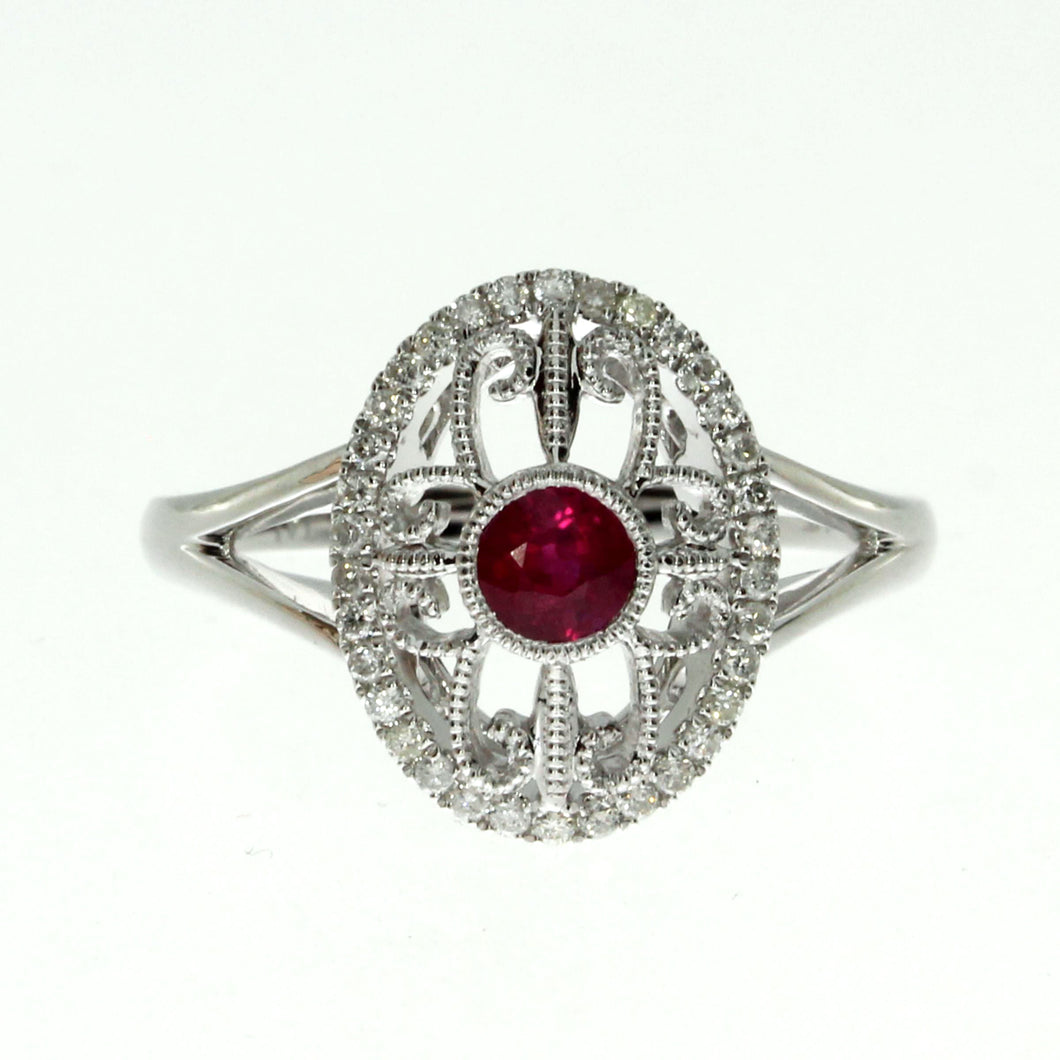  14 karat white gold ruby and diamond oval filigree ring containing one 0.36ct round ruby and 0.17cttw round diamonds.